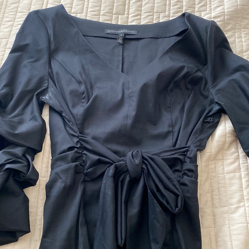 Black puffy sleeved blouse with tie front and side zipper.